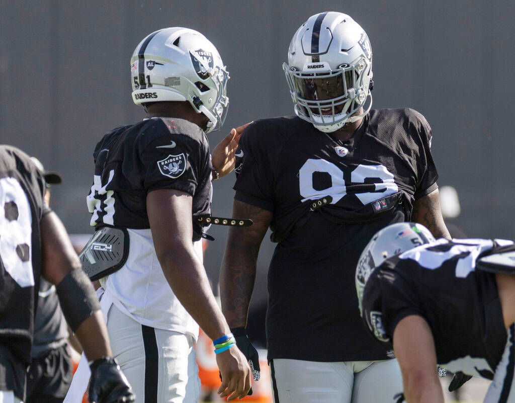 Raiders defensive end Malcolm Koonce (51) and defensive tackle Neil Farrell Jr. (93) meet on th ...