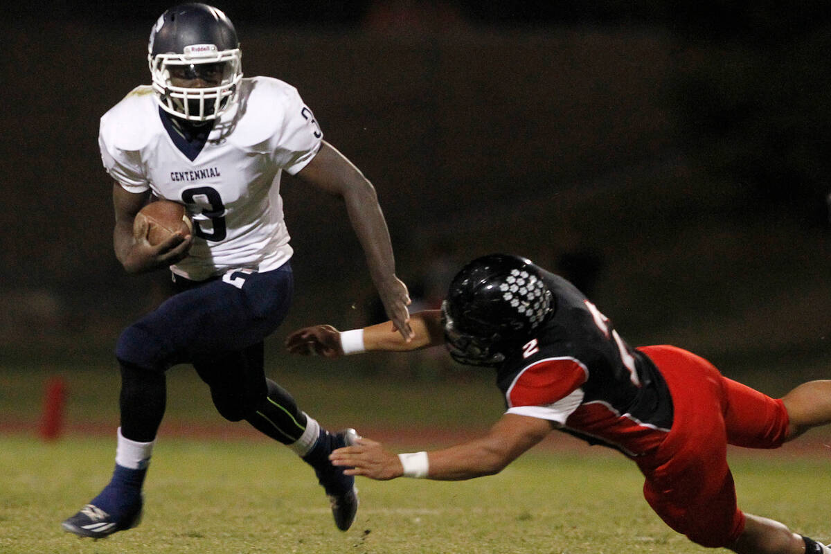 Centennial running back Rhamondre Stevenson eludes Las Vegas defender Jacob Littlefield at Las ...