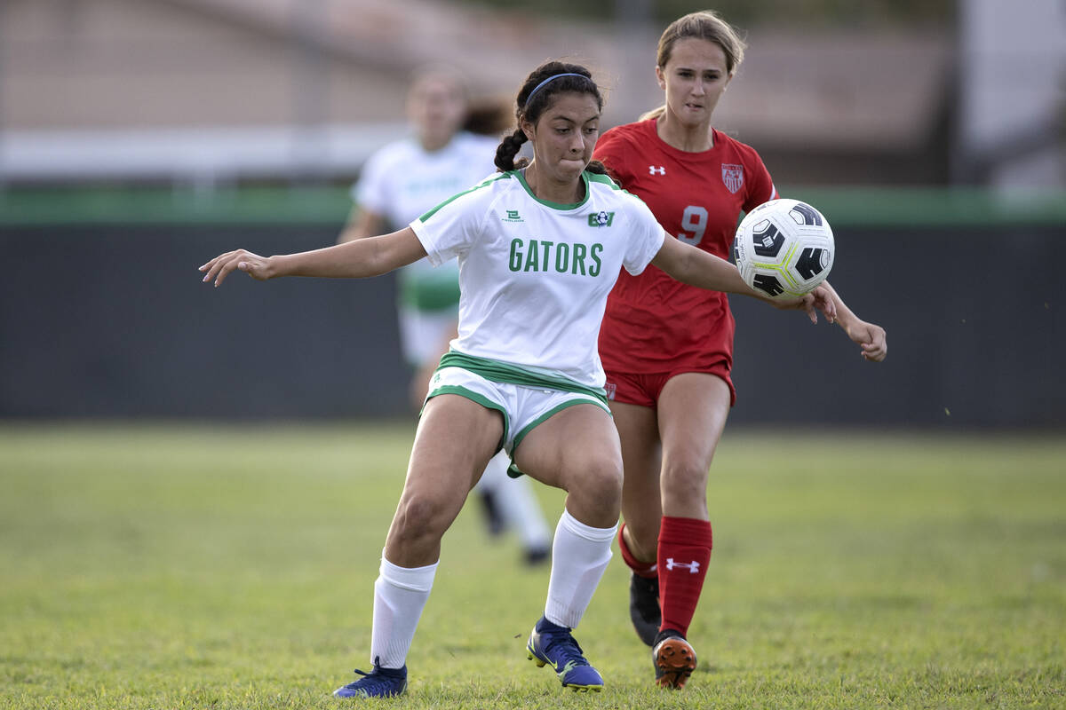 Green Valley’s Ella Drakulich (11) and Arbor View’s Darien Cox (9) run for the ba ...