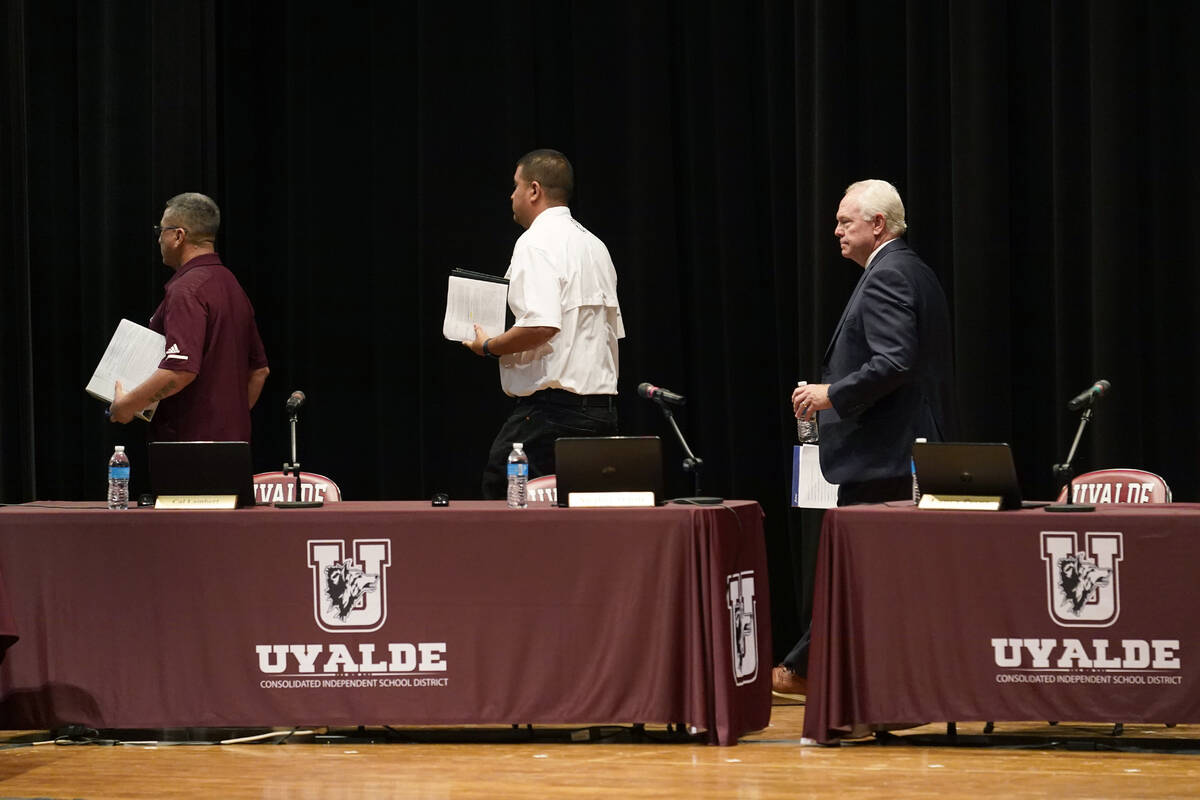 Dr. Hal Harrell, right, and members of the Board of Trustees of Uvalde Consolidated Independent ...