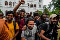 Protesters cheer as they leave prime minister Ranil Wickremesinghe's office building in Colombo ...