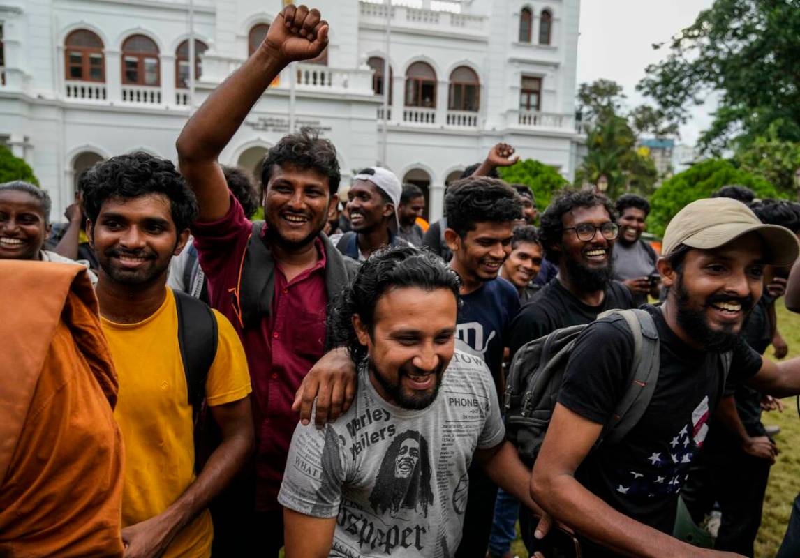 Protesters cheer as they leave prime minister Ranil Wickremesinghe's office building in Colombo ...