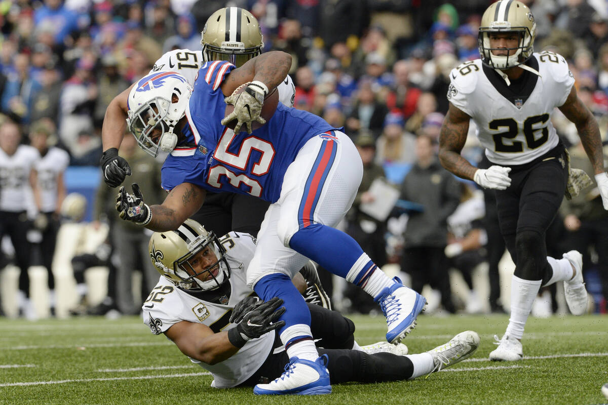 Buffalo Bills fullback Mike Tolbert (35) breaks a tackle by New Orleans Saints' Craig Robertson ...