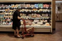 A man shops at a supermarket on Wednesday, July 27, 2022, in New York. An inflation gauge that ...