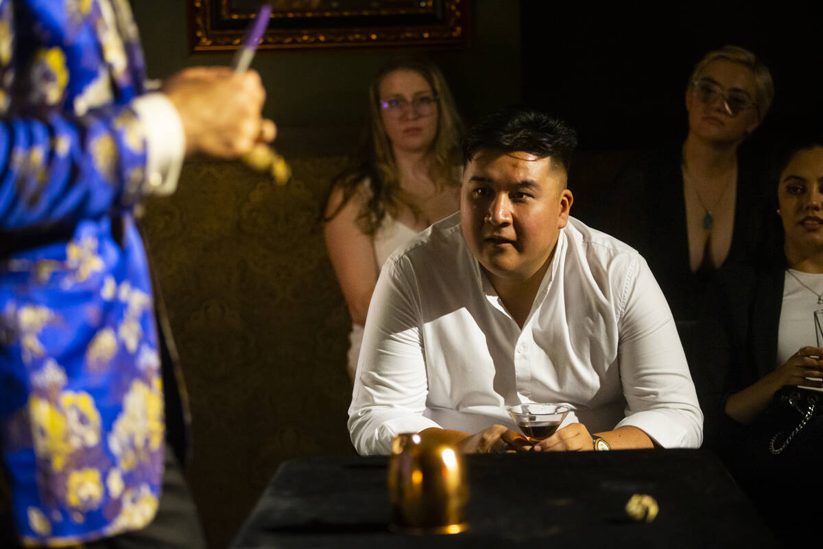Carlos Rivera, of El Paso, Texas, watches closely as The Magician, of The Magician's Study, per ...