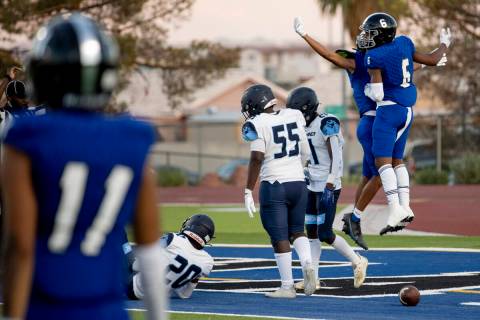 Desert Pines freshman Isaiah Nickels (2) celebrates with freshman Billy Ross (6) after a touchd ...