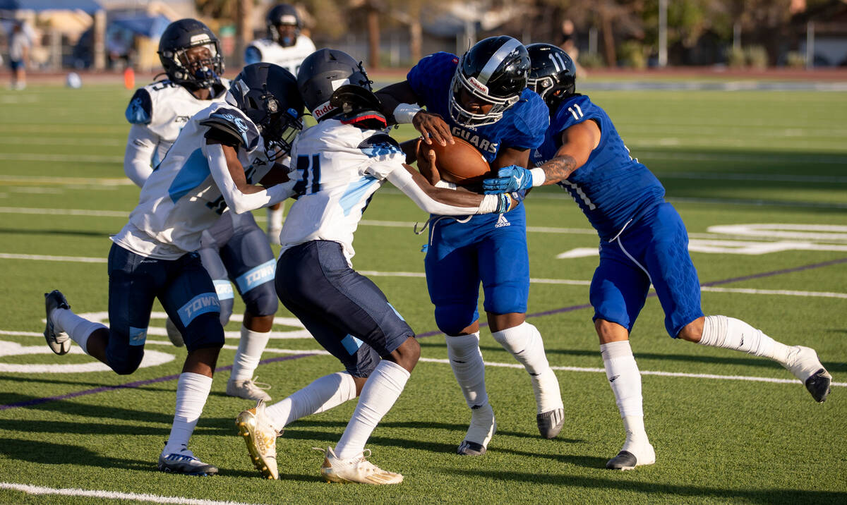 Desert Pines junior Marquis Roby (1) tries to break through the Canyon Springs defense in the f ...