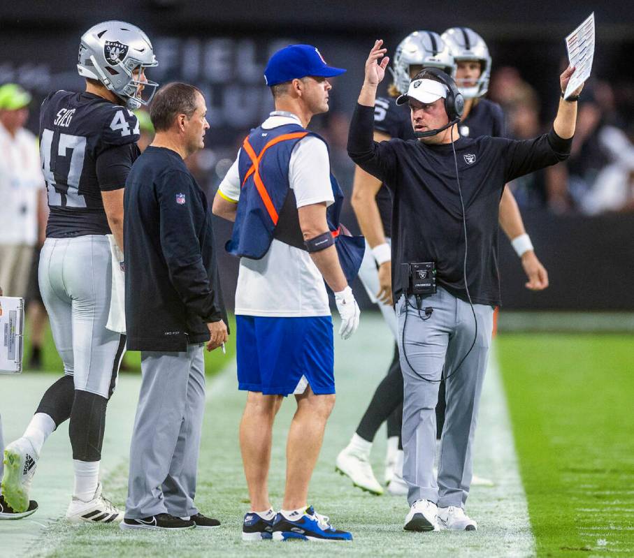 Raiders head coach Josh McDaniels is unhappy with a player on the sidelines versus the Patriots ...