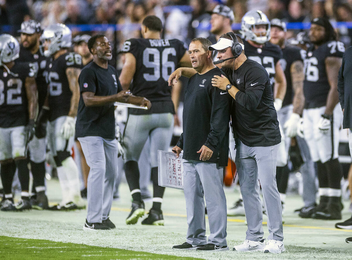 Raiders Special Teams Coordinator Tom McMahon, left, talks with head coach Josh McDaniels on th ...