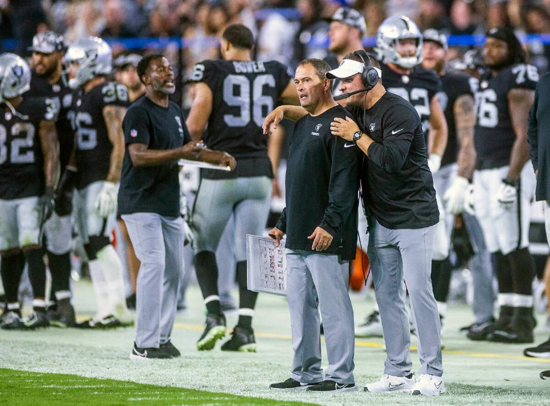 Raiders Special Teams Coordinator Tom McMahon, left, talks with head coach Josh McDaniels on th ...