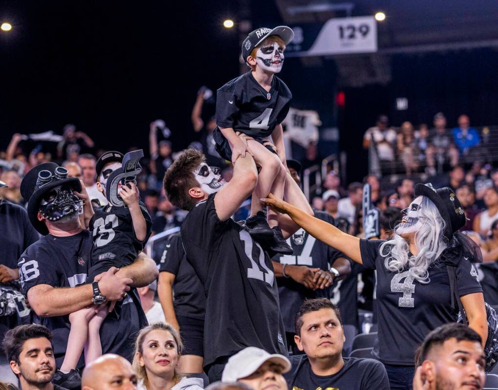 Raiders fans celebrate another win, this versus the New England Patriots during the second half ...