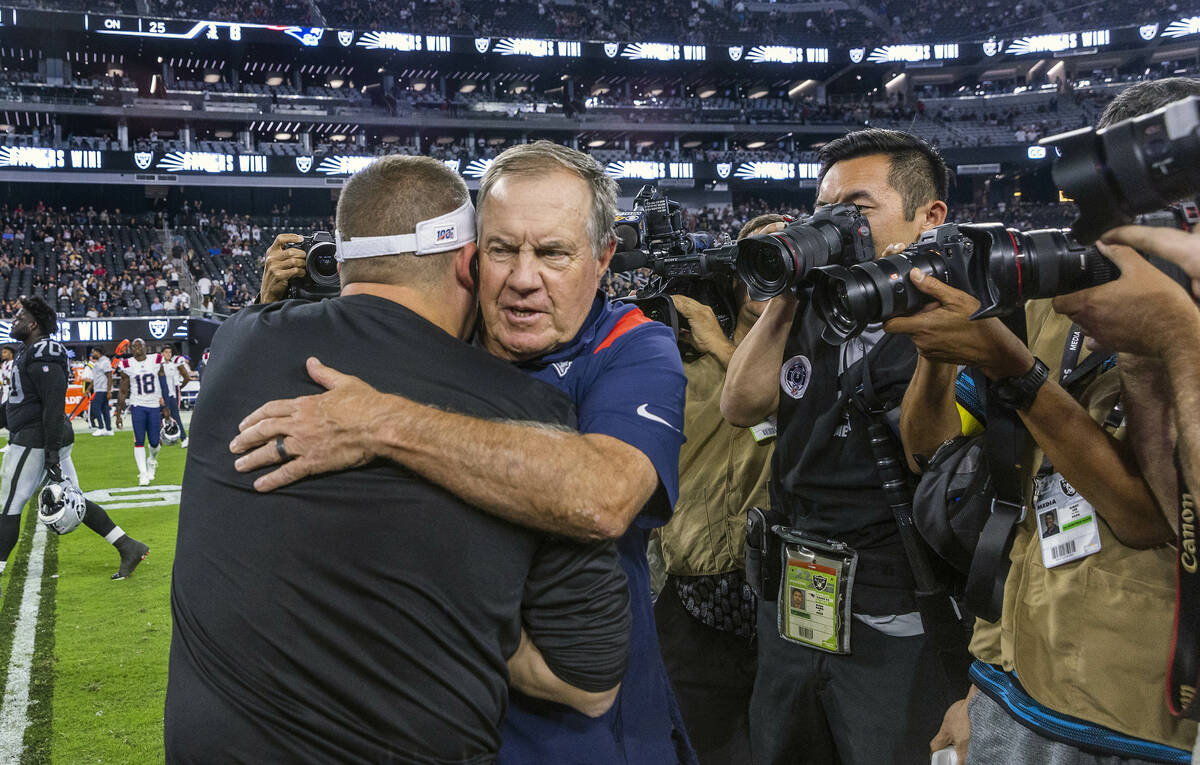 New England Patriots Head Coach Bill Belichick hugs Raiders Head Coach Josh McDaniels on the fi ...