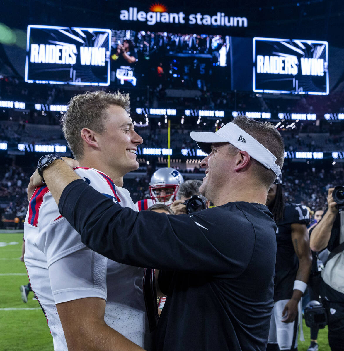 New England Patriots quarterback Mac Jones (10) greets Raiders Head Coach Josh McDaniels on the ...