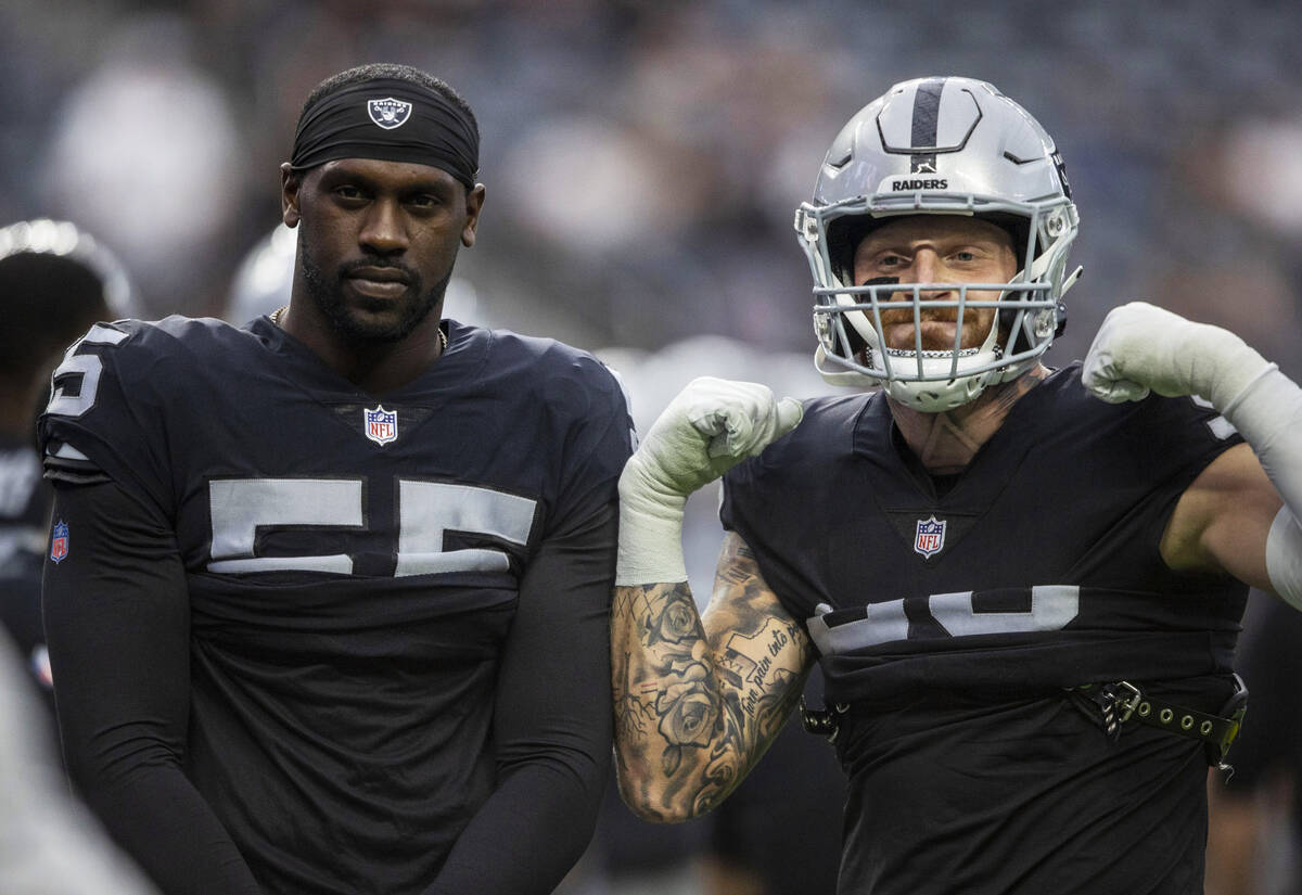 Raiders defensive ends Chandler Jones (55) and Maxx Crosby (98) pose before an NFL game against ...