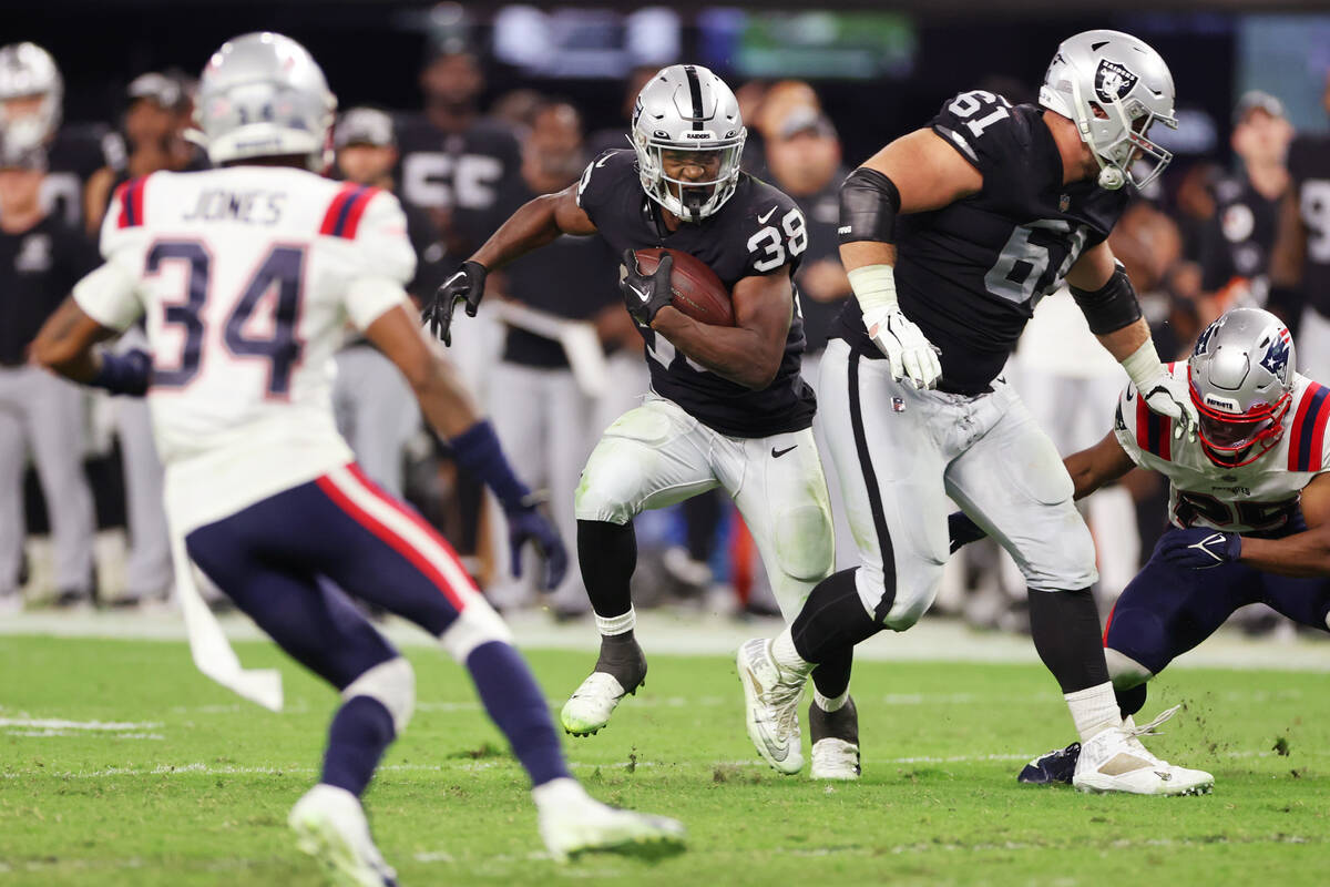 Raiders running back Brittain Brown (38) runs the ball against the New England Patriots during ...