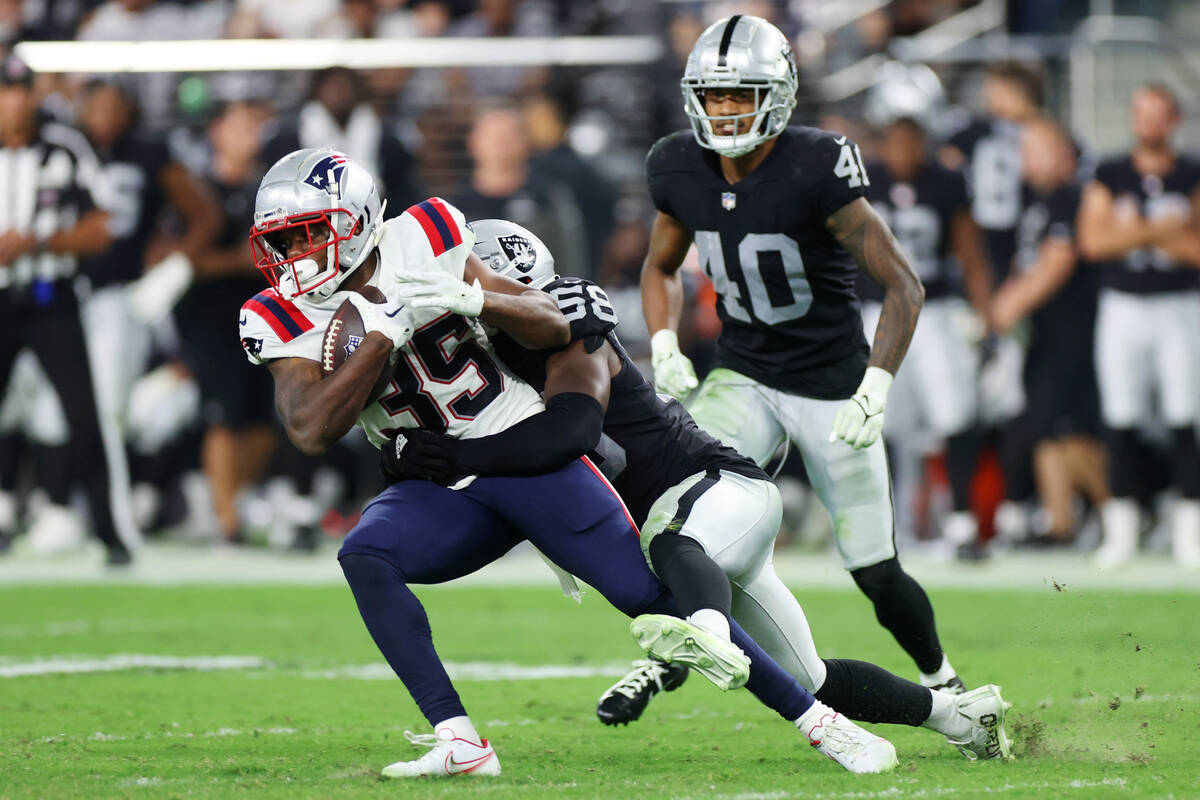 Raiders linebacker Darien Butler (58) tackles New England Patriots safety Brad Hawkins (35) dur ...