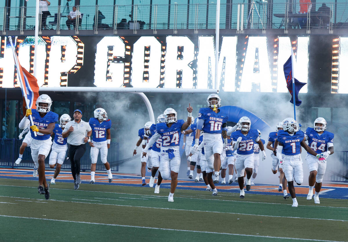 Bisho Gorman players take the field to face Mater Dei High at Bishop Gorman High School on Frid ...
