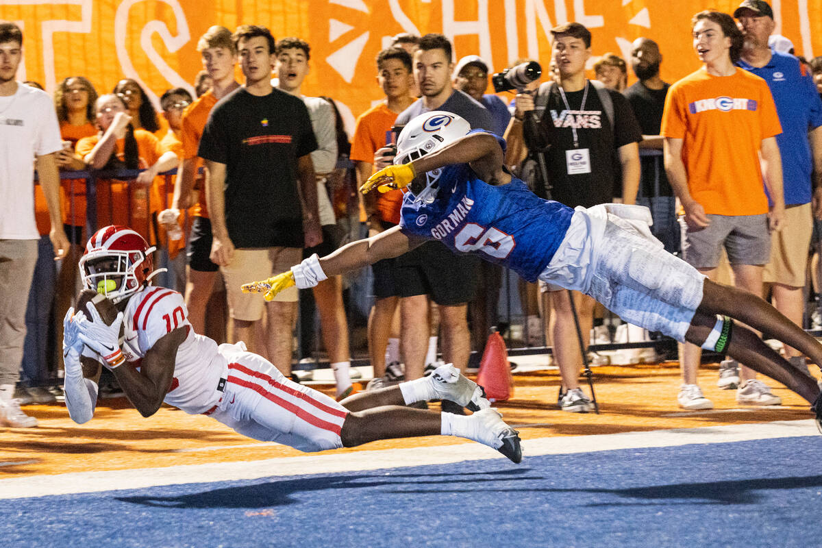 Mater Dei's wide receiver Marcus Harris (10) dives to catch a touchdown pass as Bisho Gorman's ...