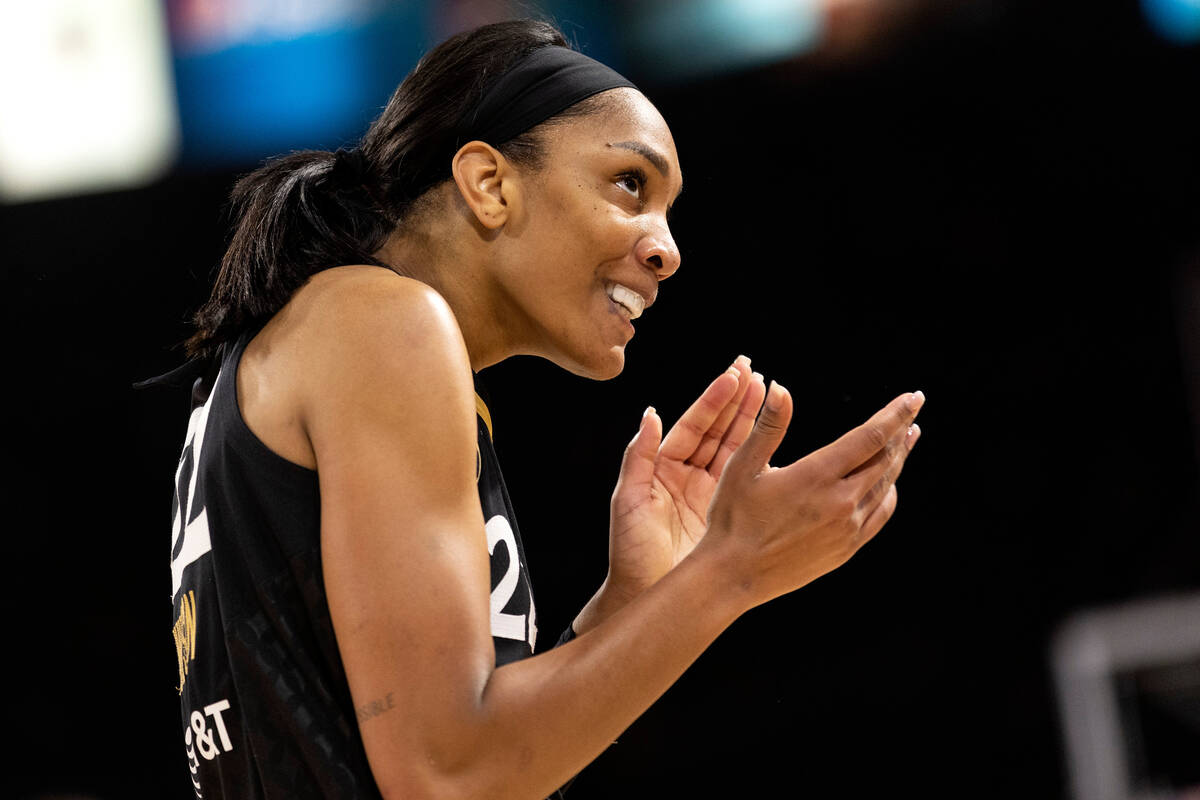 Las Vegas Aces forward A'ja Wilson (22) claps to the crowd after a referee called a foul on the ...