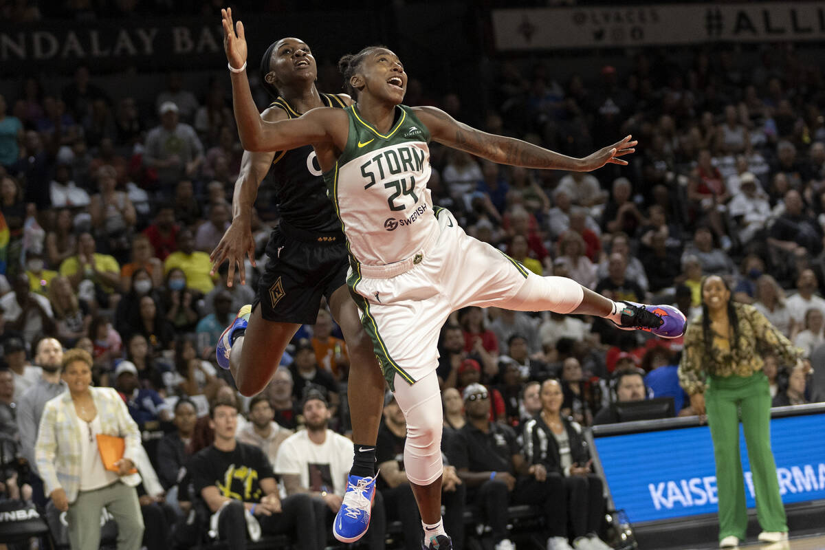 Las Vegas Aces guard Jackie Young (0) fouls Seattle Storm guard Jewell Loyd (24) while jumping ...