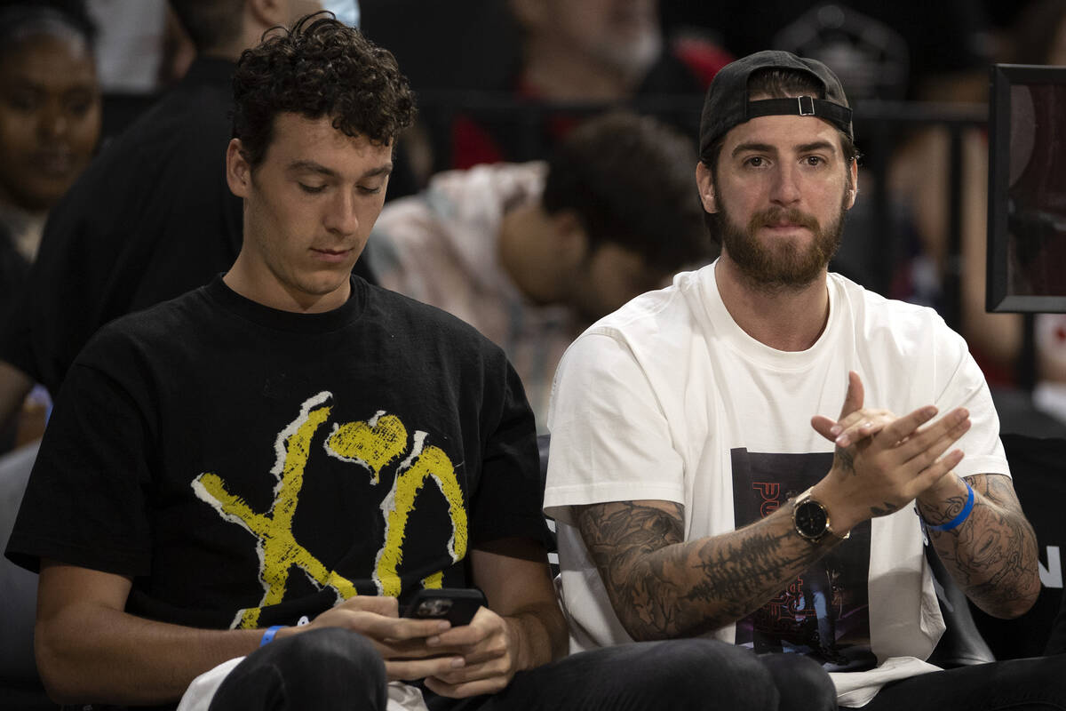 Vegas Golden Knights goaltender Logan Thompson, left, claps for the Las Vegas Aces during the s ...