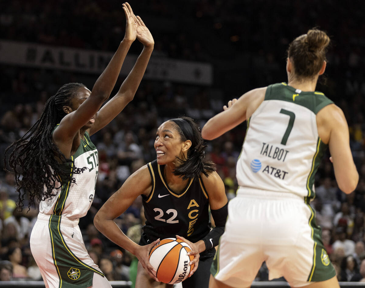 Las Vegas Aces forward A'ja Wilson (22) shoots against Seattle Storm center Ezi Magbegor, left, ...