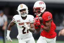 UNLV Rebels wide receiver Ricky White (11) makes a catch under pressure from Idaho State Bengal ...