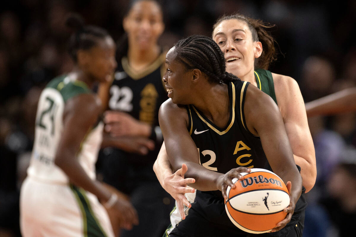 Seattle Storm forward Breanna Stewart, behind, defends while Las Vegas Aces guard Chelsea Gray ...