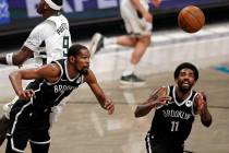 Brooklyn Nets forward Kevin Durant (7) and Kyrie Irving go for a rebound against the Milwaukee ...
