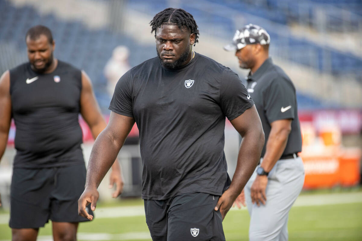 Raiders offensive tackle Alex Leatherwood warms up on the field before the NFL Hall of Fame gam ...