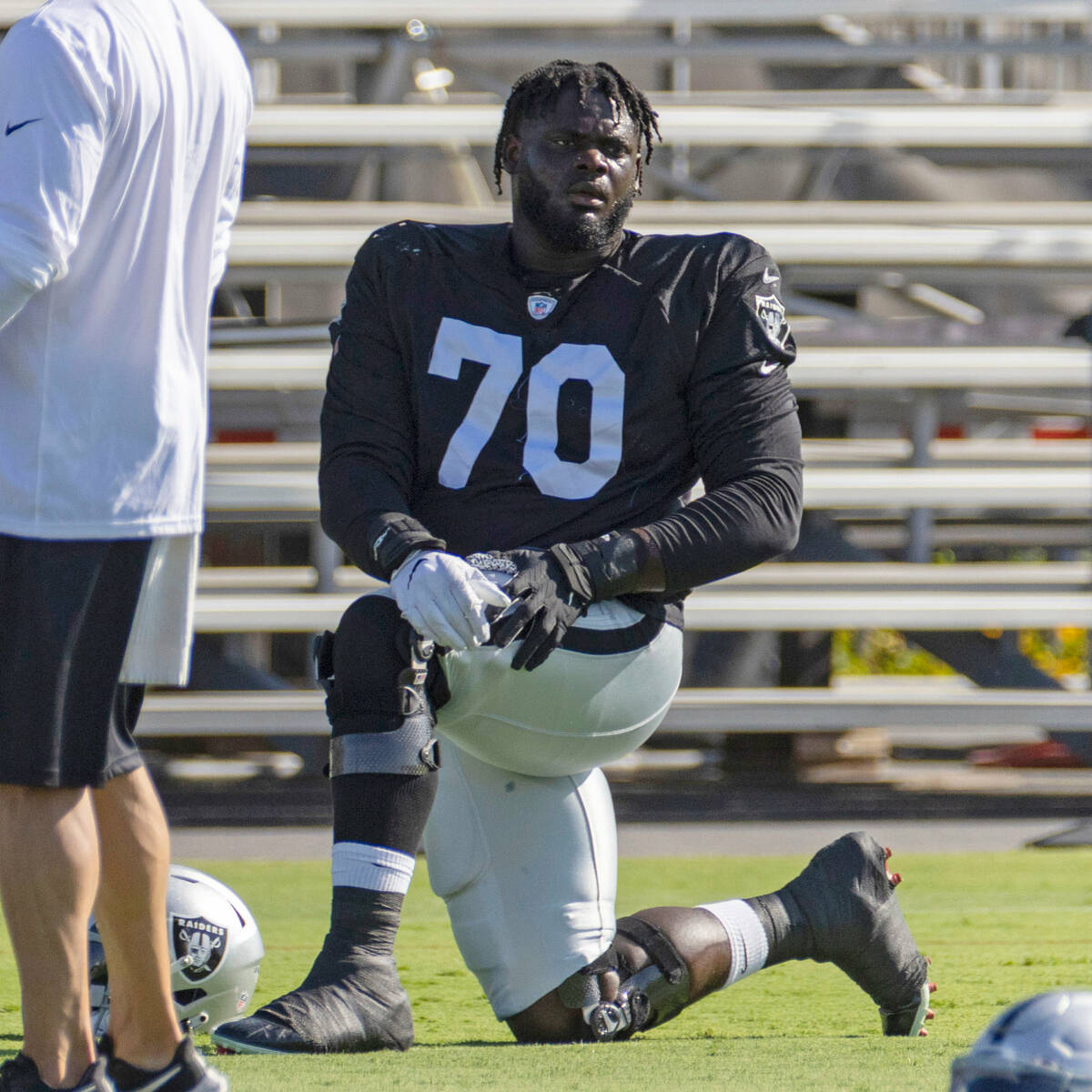 Raiders offensive tackle Alex Leatherwood (70) stretches during the team’s training camp ...