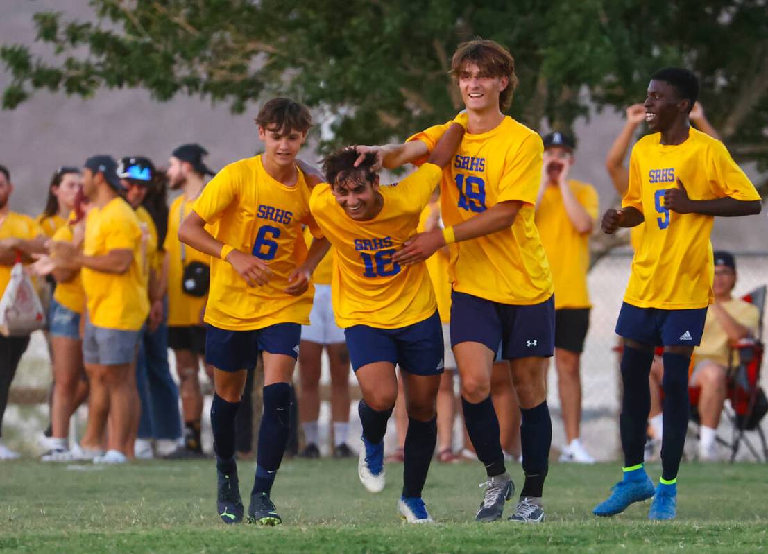Shadow Ridge midfielder Gavin Houghton (16) celebrates his goal with teammates during a soccer ...
