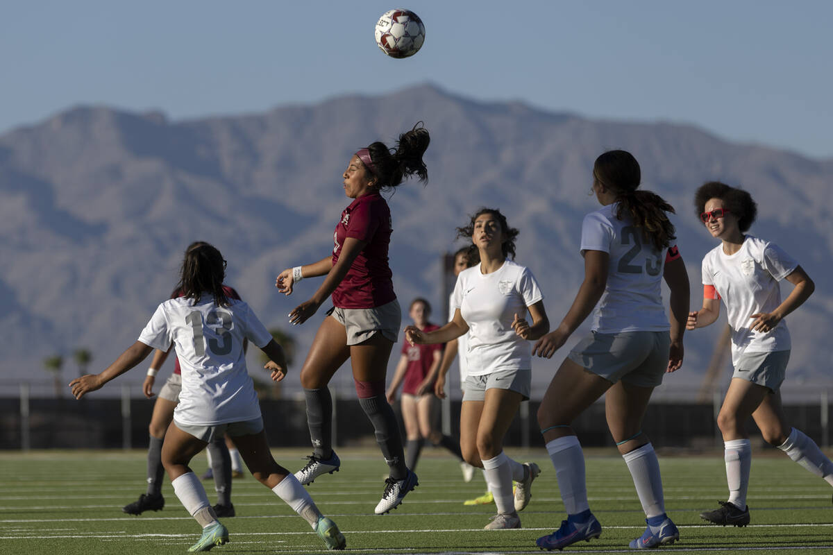Cimarron-Memorial midfielder Kasandra Dominguez (9) heads the ball as Bonanza players close in ...