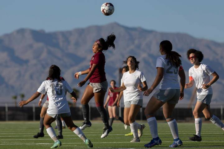 Cimarron-Memorial midfielder Kasandra Dominguez (9) heads the ball as Bonanza players close in ...