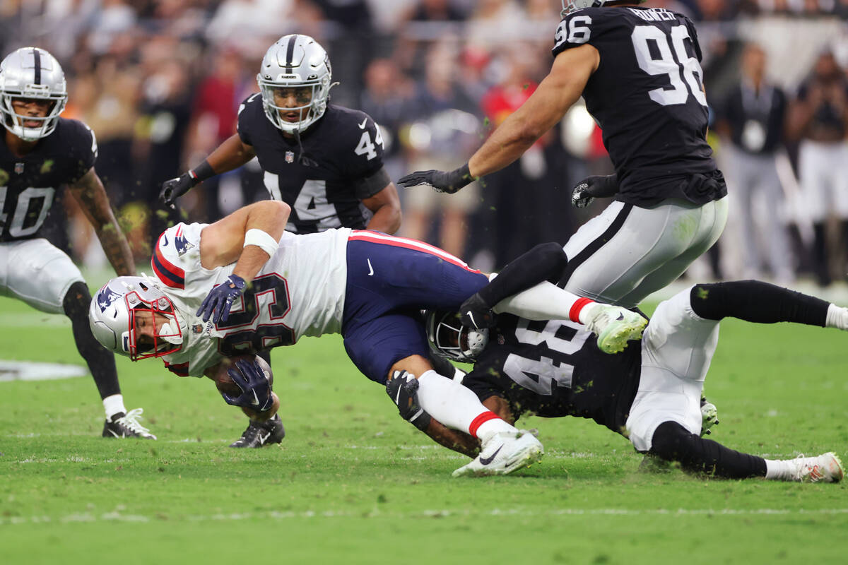 Raiders cornerback Sam Webb (48) tackles New England Patriots tight end Hunter Henry (85) durin ...
