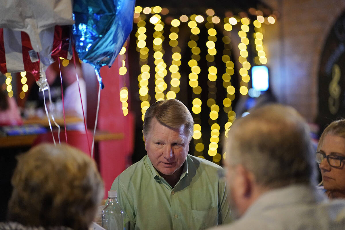 Jim Marchant, center, the GOP nominee for secretary of state in Nevada, speaks with people at a ...