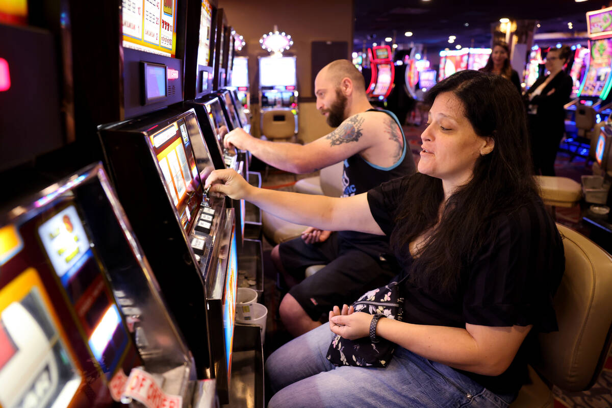 Audra Robison and her husband Neil, of Salt Lake City, play coin slot machines at Circus Circus ...