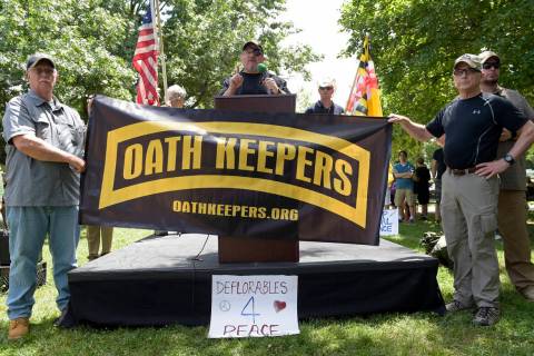 Stewart Rhodes, founder of the citizen militia group known as the Oath Keepers, center, speaks ...