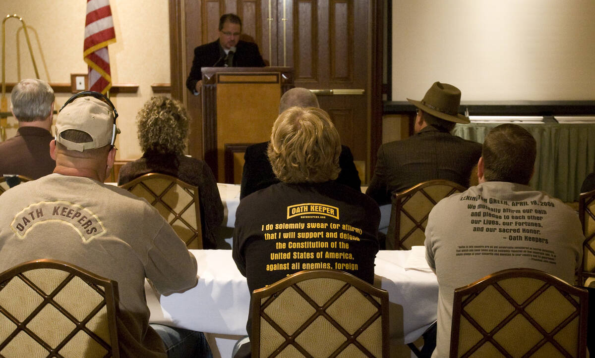 Oath Keepers members and guests listen to Oath Keepers National President Stewart Rhodes at the ...
