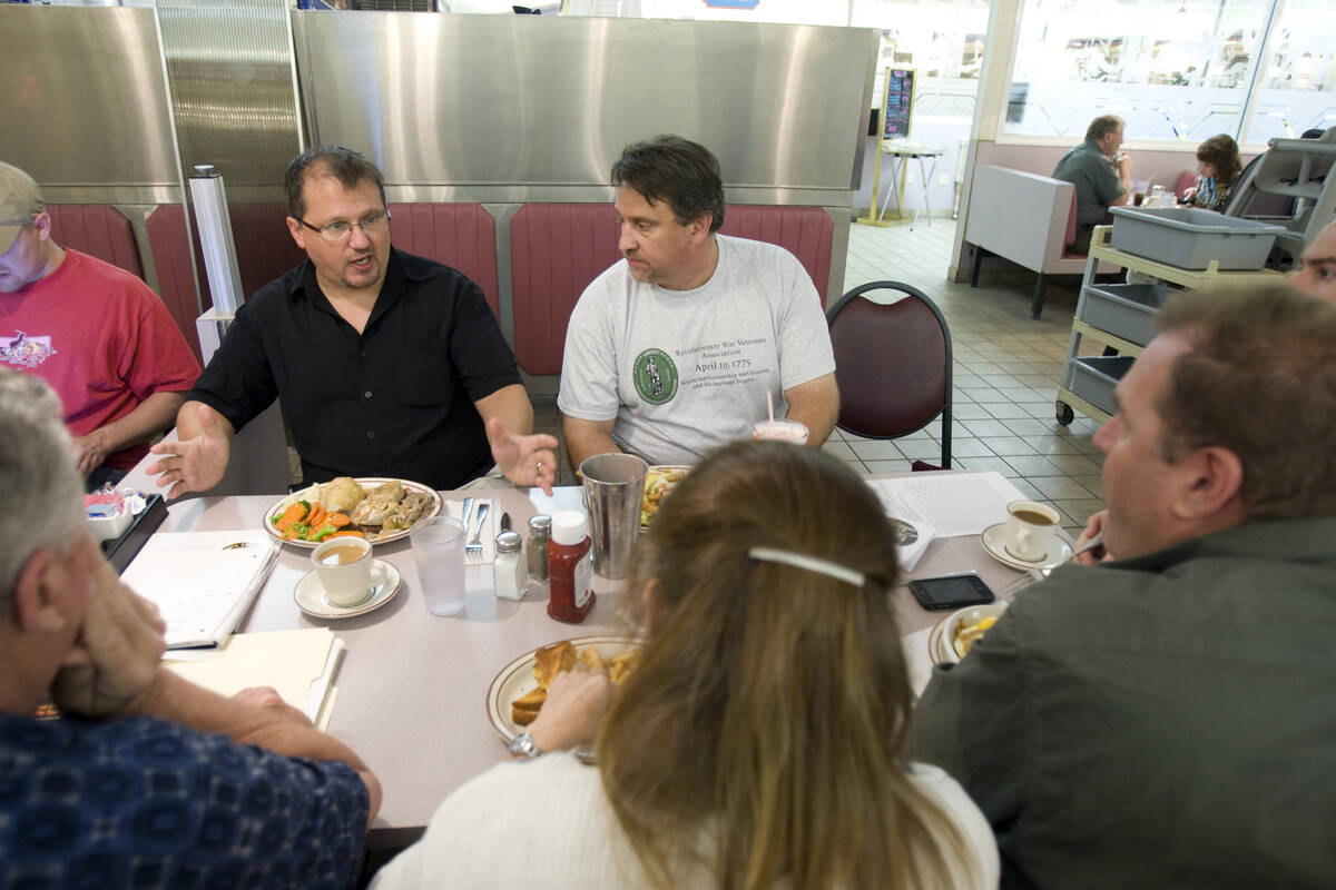 Stewart Rhodes, founder and spokesman of the Oath Keepers, second from left, talks during an me ...