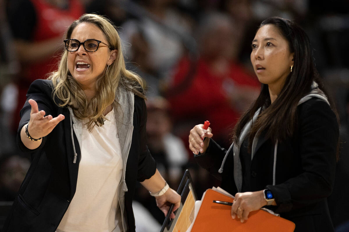 Las Vegas Aces head coach Becky Hammon, left, and assistant coach Natalie Nakase communicate wi ...