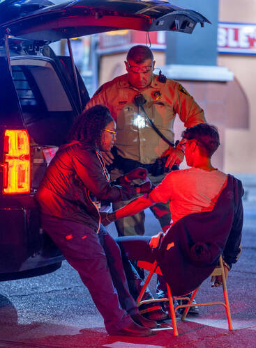 Ashley Webber-Gamboa with Sunrise Pathology Services, left, draws blood from Mike Soto, right, ...