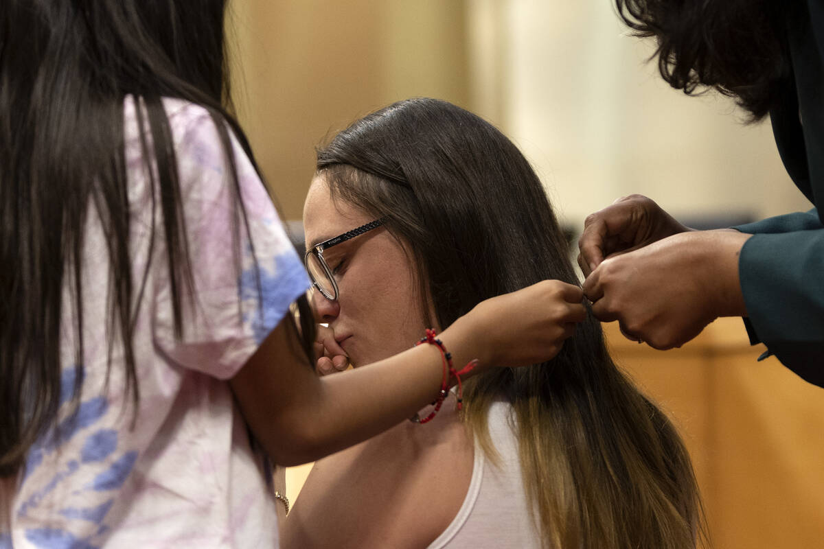 Bridget Stevens kisses her daughter Aaliyah Hernandez’s hand as she and Councilwoman Oli ...