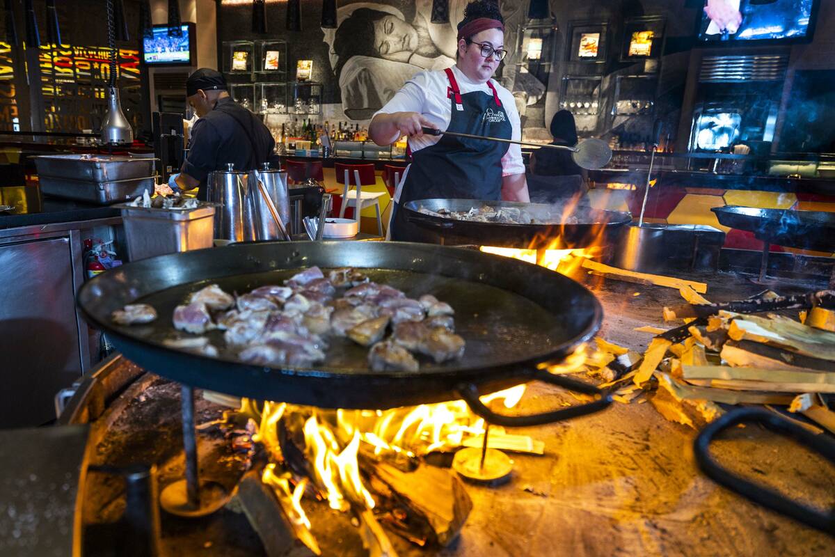 Chef Stephanie Sandfrey prepares Paella over an open flame at Jaleo in The Cosmopolitan of Las ...