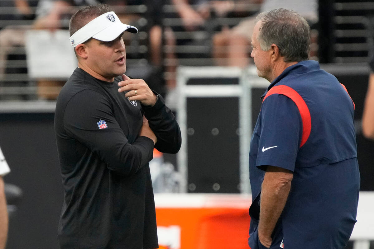 Las Vegas Raiders head coach Josh McDaniels talks to New England Patriots head coach Bill Belic ...