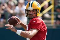 Green Bay Packers' Aaron Rodgers runs a drill before an NFL football joint practice session wit ...