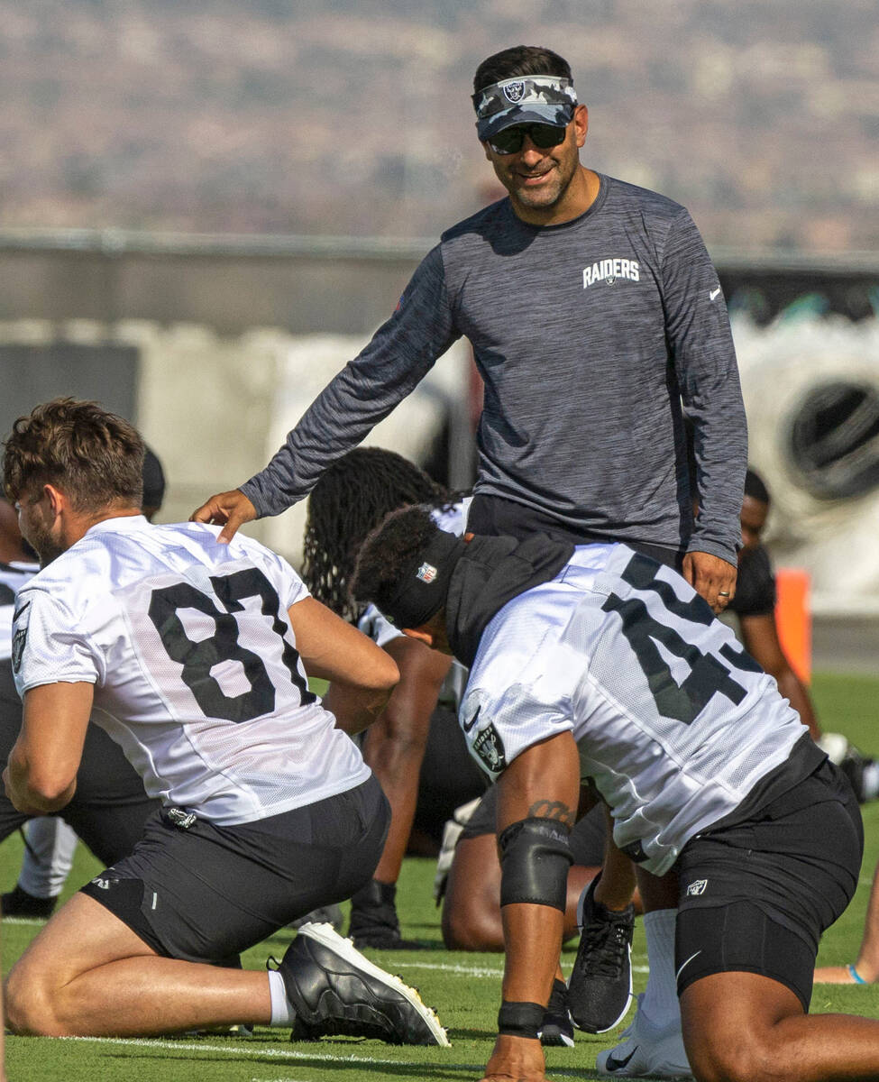 Raiders general manager Dave Ziegler greets tight end Foster Moreau (87) during the team’ ...