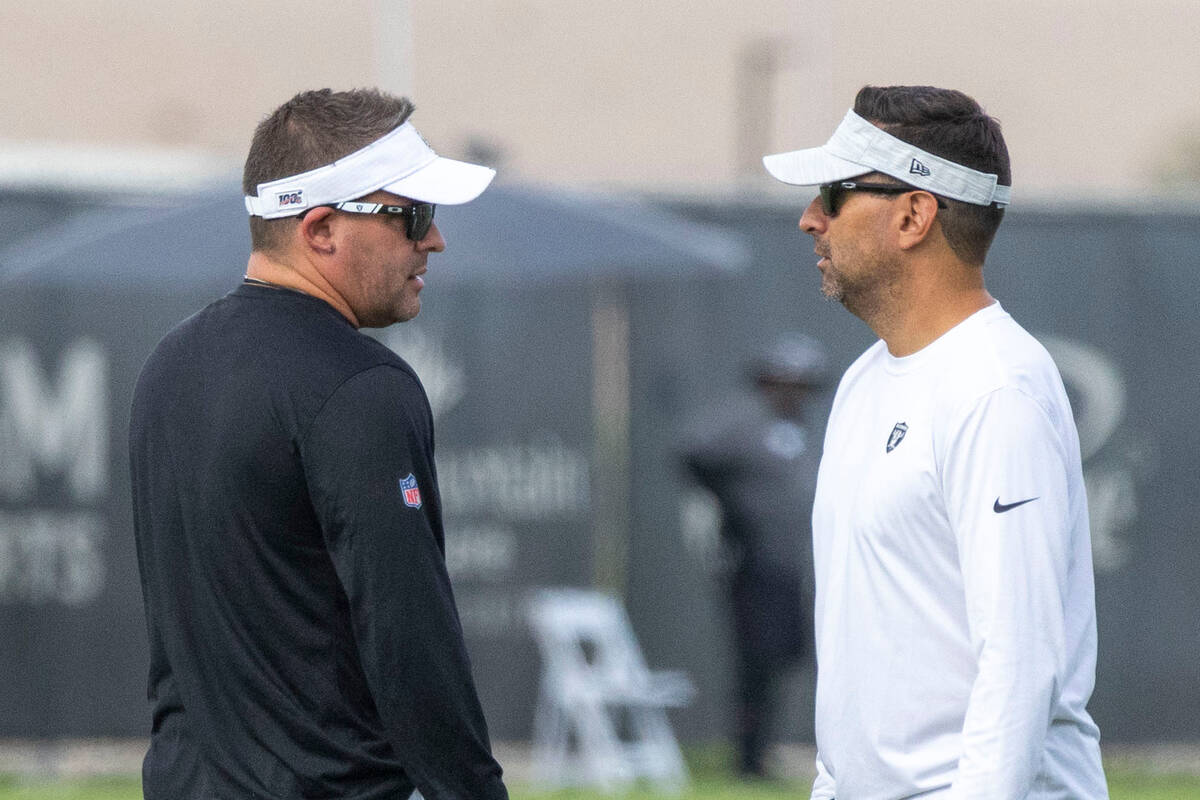Raiders head coach Josh McDaniels, left, and general manager Dave Ziegler have a conversation d ...