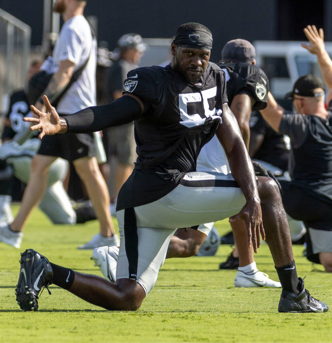 Raiders defensive end Chandler Jones (55) stretches during the team’s training camp prac ...