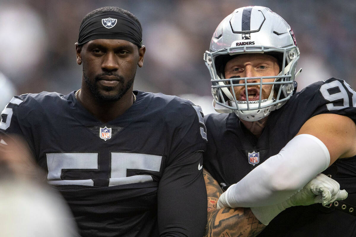 Raiders defensive ends Chandler Jones (55) and Maxx Crosby (98) pose before an NFL game against ...